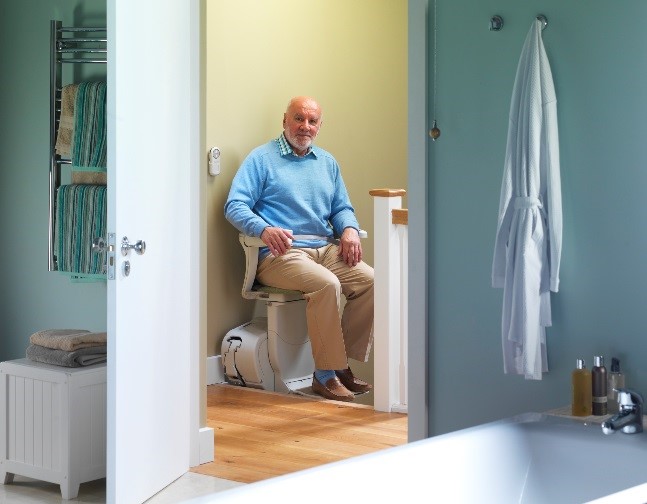 man in stair lift at home
