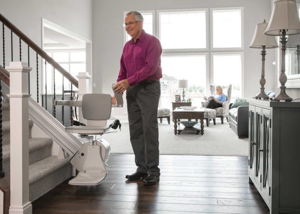 Man folding stair lift armrest