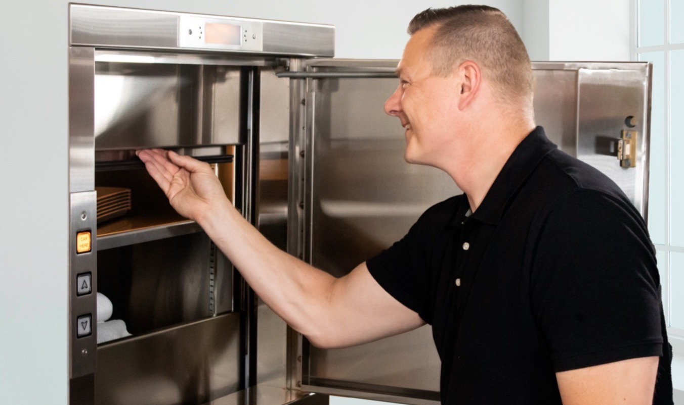 Man opening dumbwaiter