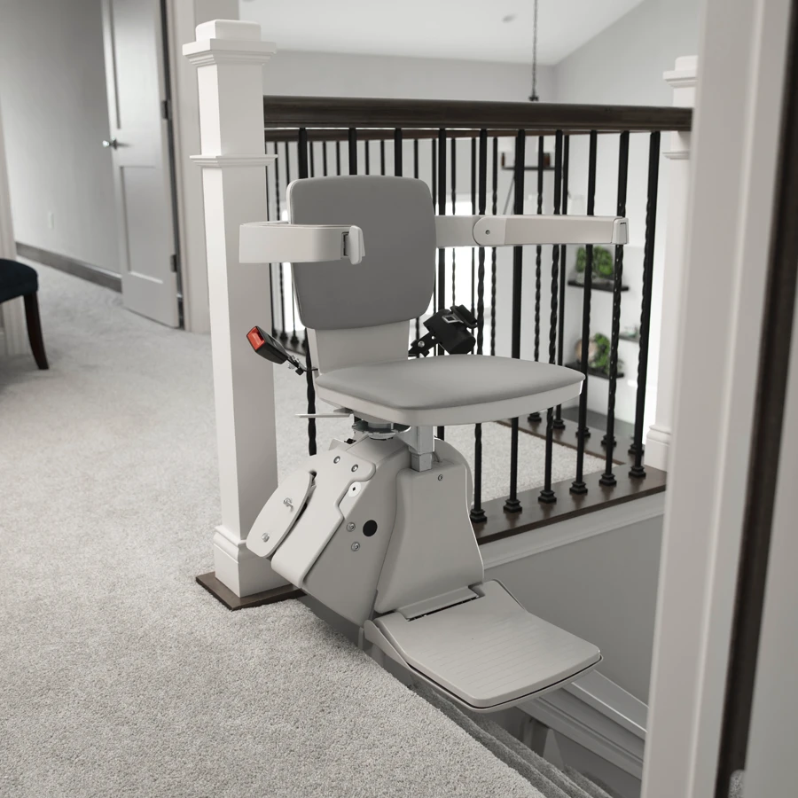 White stairlift at the top of stairs