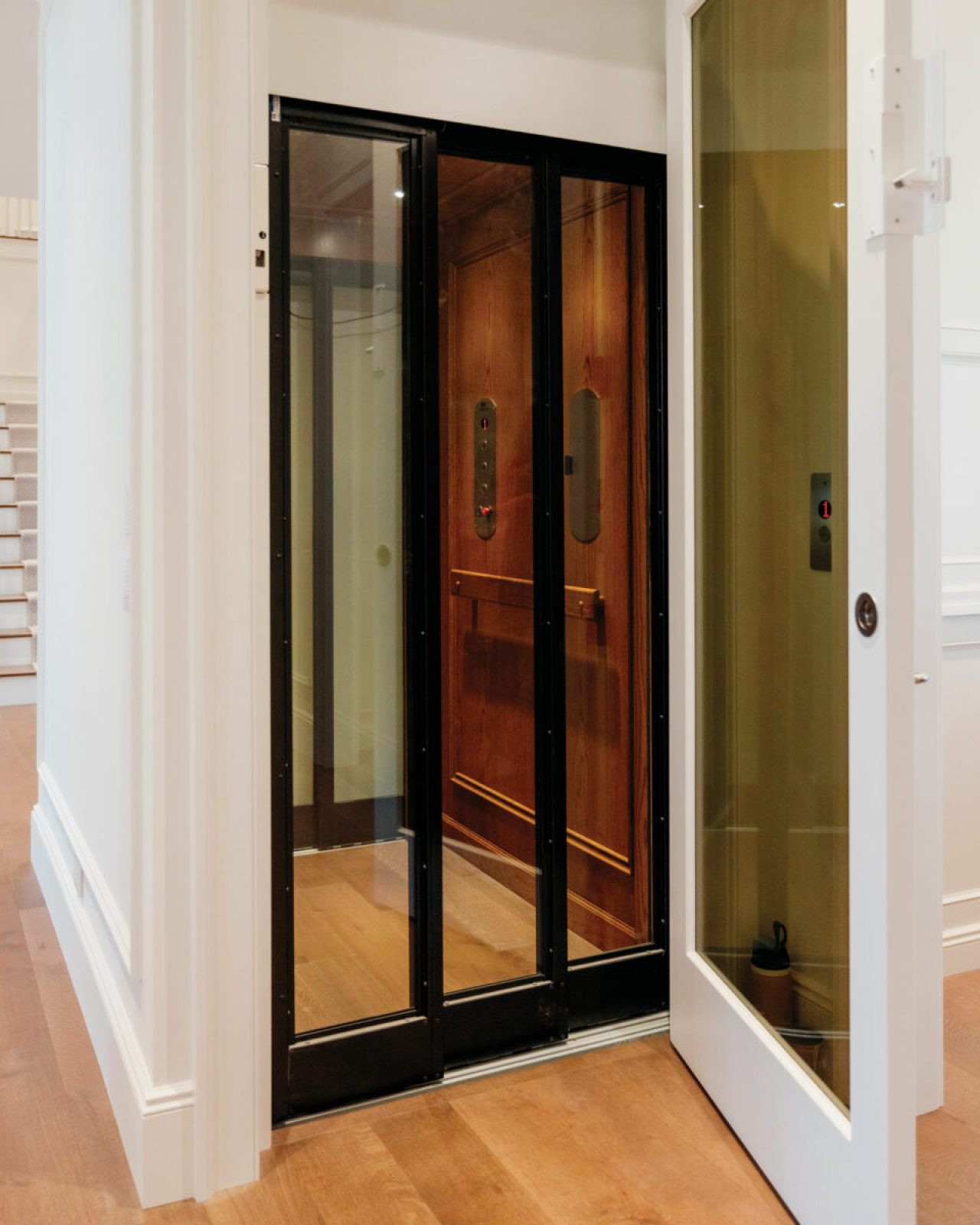 Luxury home elevator with black framed glass door